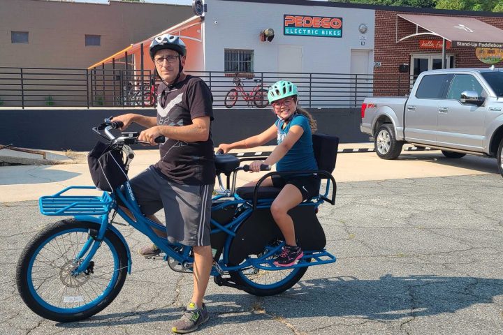 a person riding on the back of a bicycle