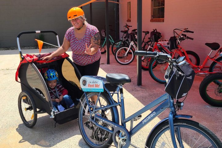 a person riding on the back of a bicycle