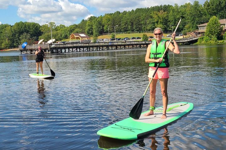 a man riding on the back of a boat in the water