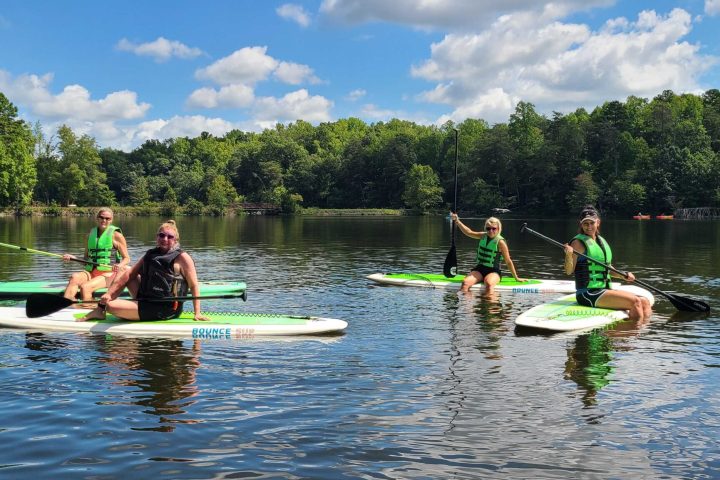 a group of people rowing a boat in the water