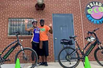 a person with a bicycle in front of a building