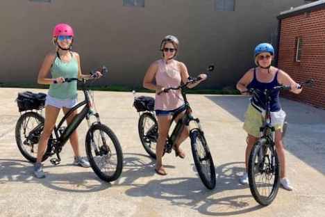 a group of people riding on the back of a bicycle