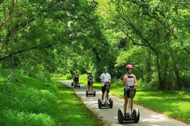 a group of people riding on the back of a motorcycle