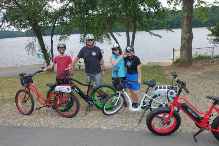 a bicycle parked in front of a group of people posing for the camera