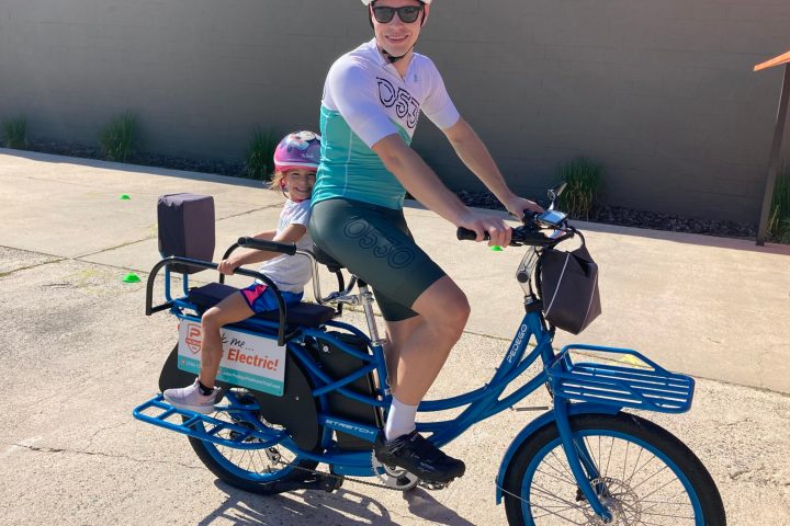 a woman sitting on a bicycle