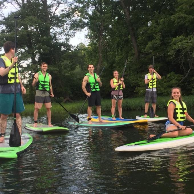 Six people enjoying the SUP on the lake