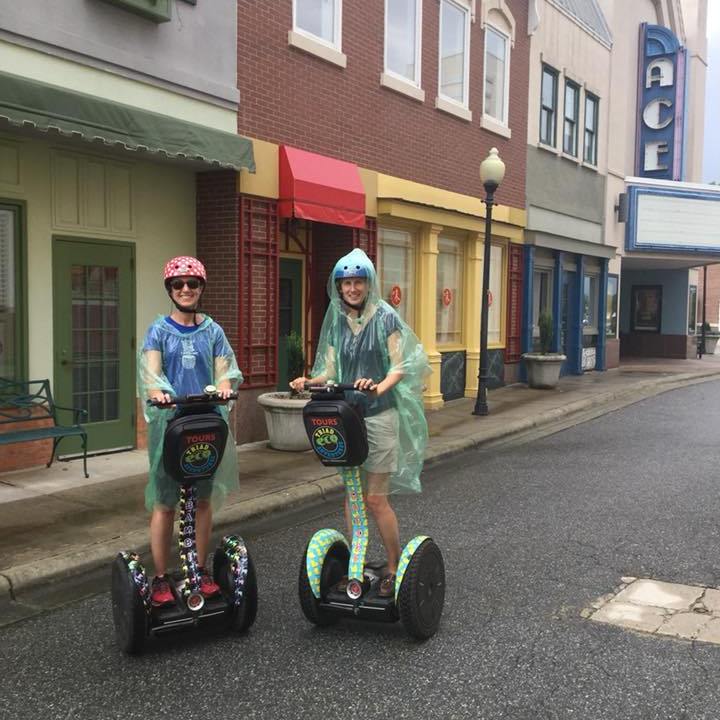 Two women in the rain riding Segway PTs