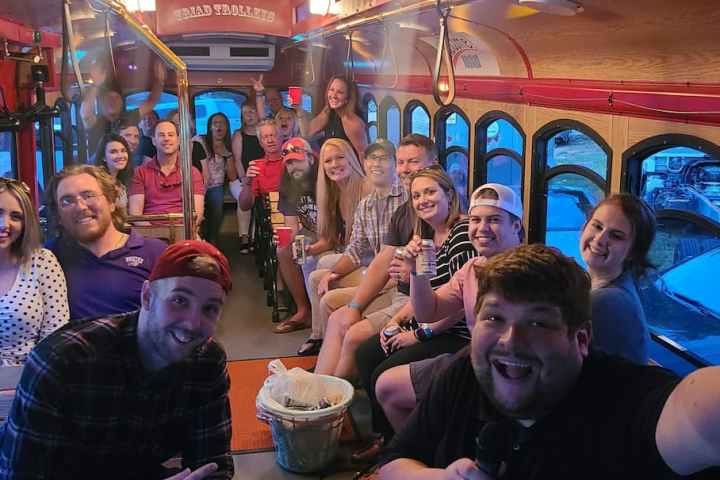 a group of people sitting at a table posing for the camera