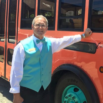 Charles Nelson Reilly standing in front of a bus