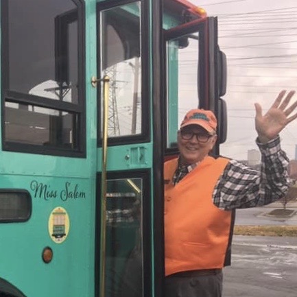a man standing in front of a bus