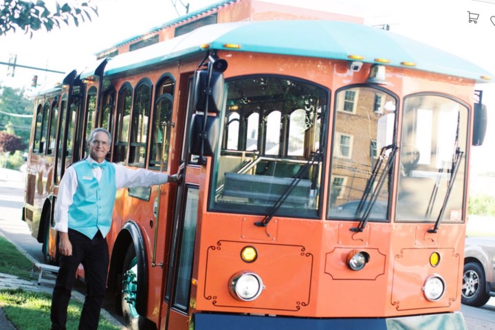 a group of people standing around a bus