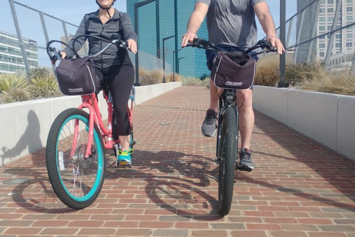 a group of people riding on the back of a bicycle