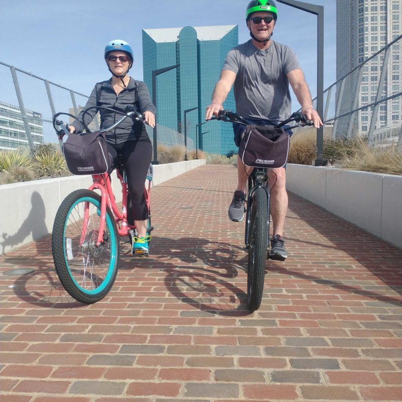 a group of people riding on the back of a bicycle