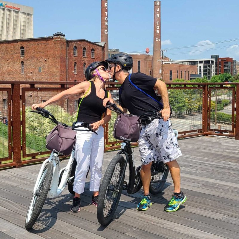 a young boy riding a skateboard up the side of a road