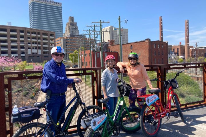 a group of people riding on the back of a bicycle