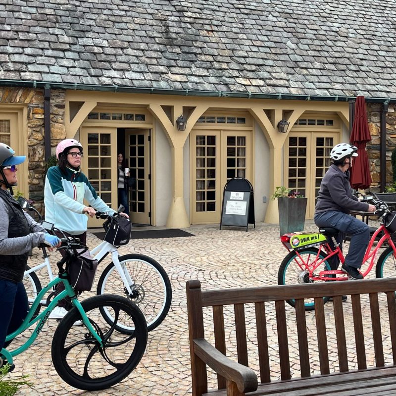 a person sitting on a bicycle in front of a building