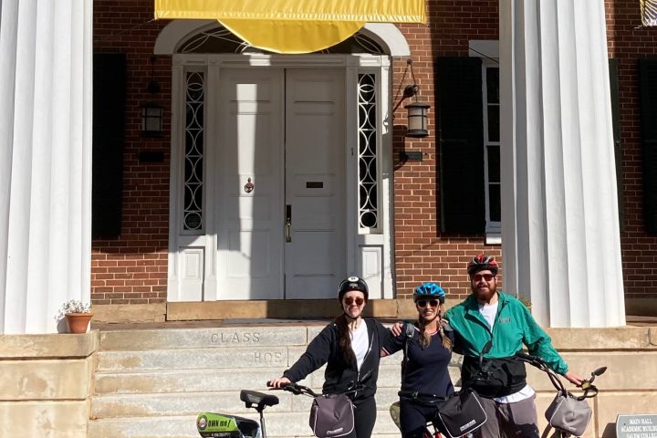 a person riding a bicycle in front of a building