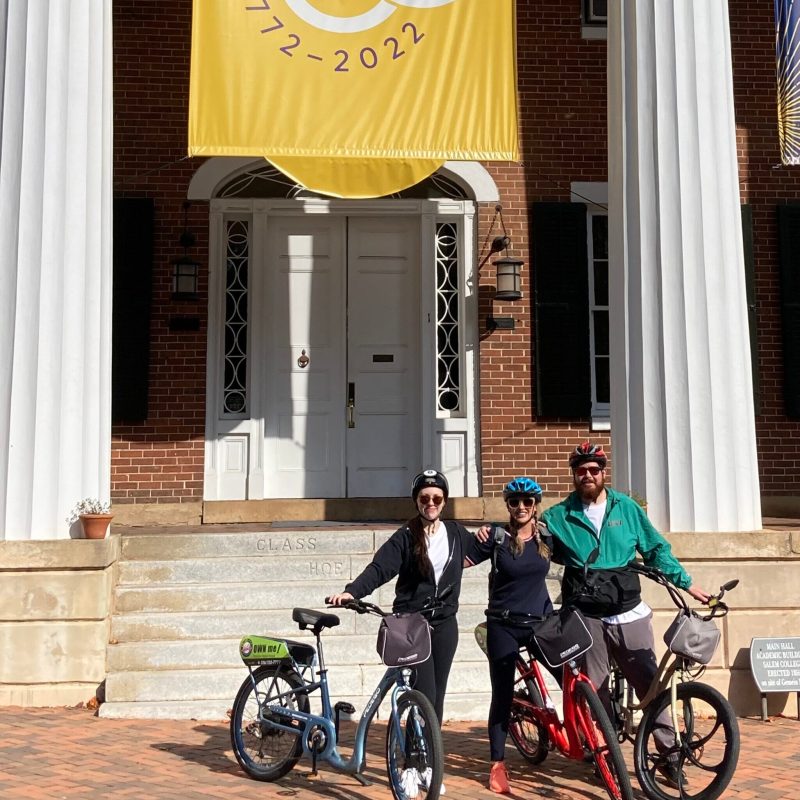 a person riding a bicycle in front of a building