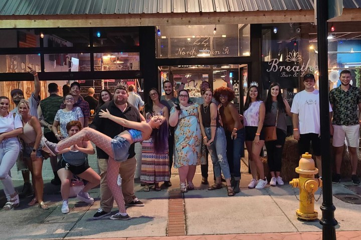 a group of people standing around a fire hydrant in front of a store