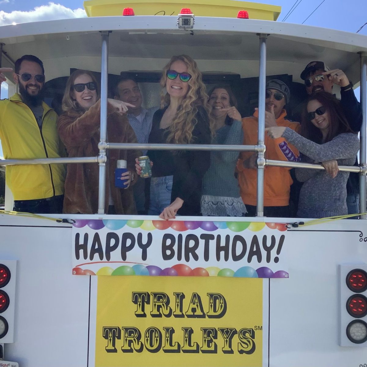 a group of people riding on the back of a truck