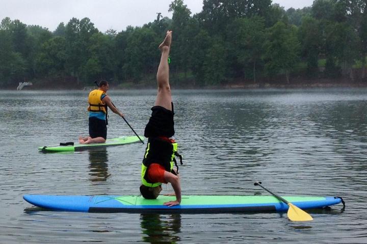 a group of people rowing a boat in the water