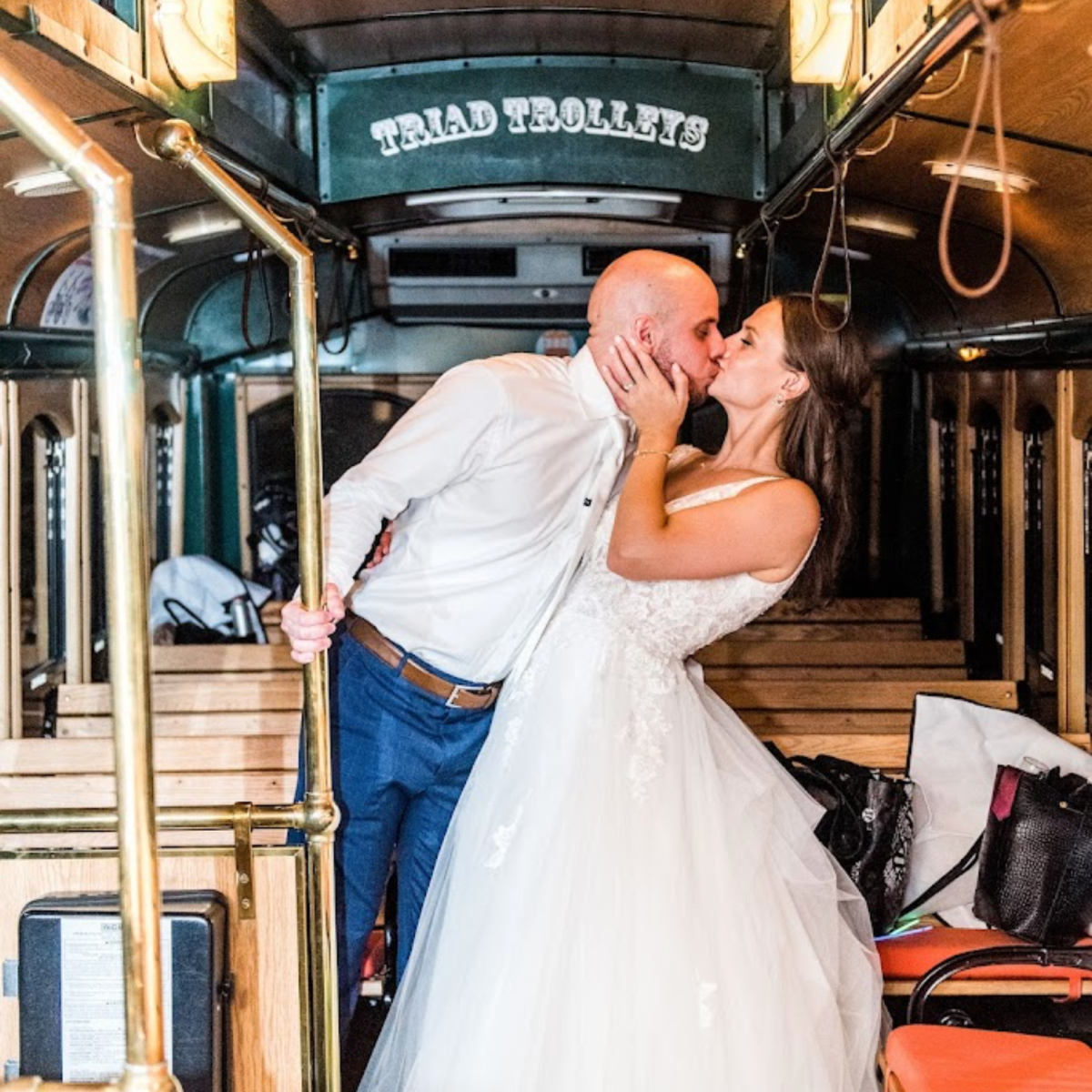 married couple kissing in triad trolleys