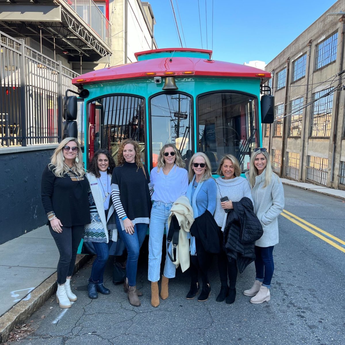 a group of people standing next to a train