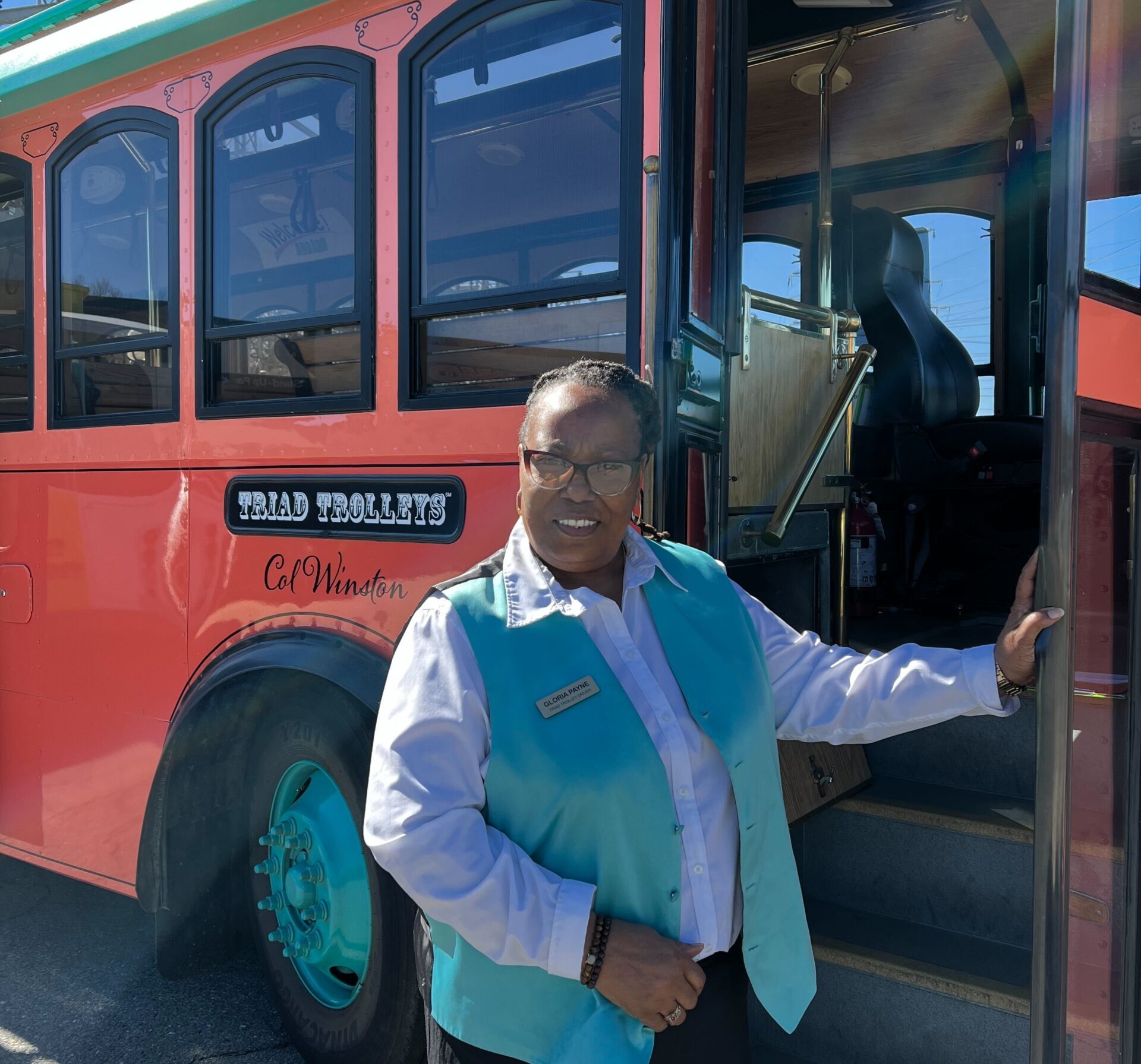 a person standing next to a bus