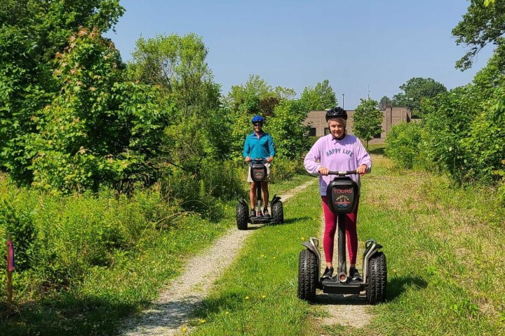 a person riding a motorcycle down a dirt road
